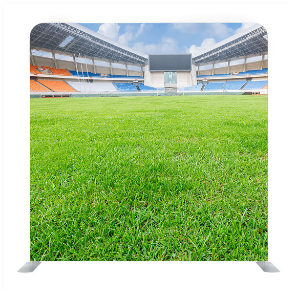Green lawn in a open stadium Media wall - Backdropsource
