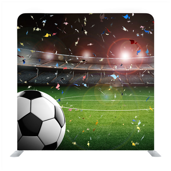 Soccer ball on green stadium with bright light flare in night Media wall - Backdropsource